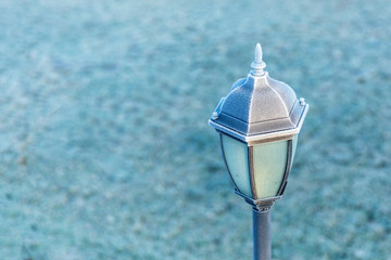 Black lantern with white hoar frost. Copy space.