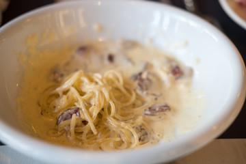 Spaghetti Carbonara served on white plate. Soft Focus.