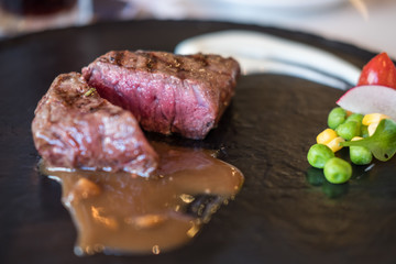 Medium rare meat on plate with sauce