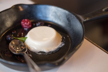 Panna Cotta on black pan with berries
