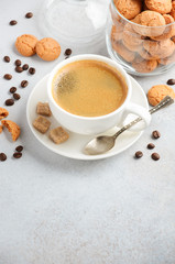 Cup of fresh coffee with Amaretti cookies on gray concrete or stone background, selective focus