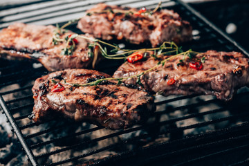 close-up view of gourmet juicy meat with spices cooking on grill