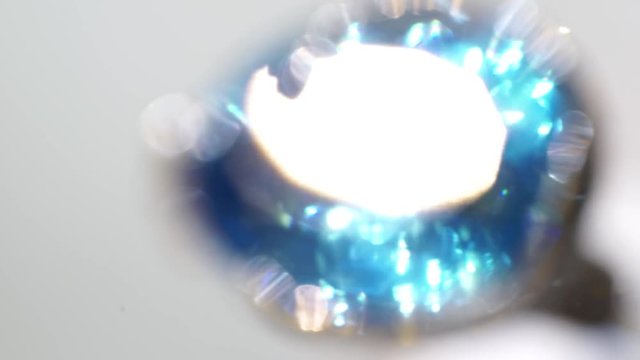 background of a transfusion of a gem of topaz, a rainbow reflection. blue glow