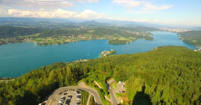 View from PyramidenKogel, biggest woden tower in the world, with 300 ft (100 m), Klagenfurt, Austria, Europe. A view to lake WortherSee and parking near tower. Famous view point place.