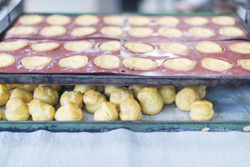 Preparing sweets , working out the dough and baking pastry in the bakery