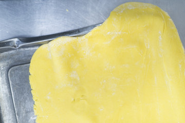 Working out the dough for pasta and cakes in the kitchen