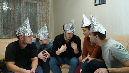 Friends in foil on the head of the house. Gathering of friends about listening to their ideas of...