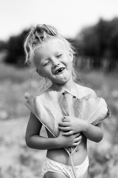 little village girl posing under a burdock