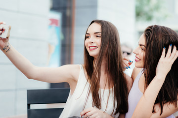 Girls make a rest in coffee and make selfies