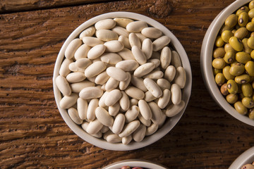 White beans on wood background