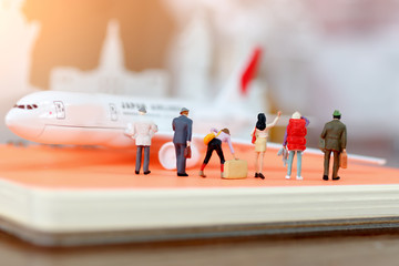 Traveling or business trip concepts. Miniature business people with baggage standing waiting for...