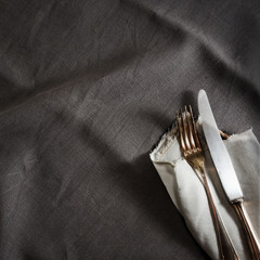 Black linen tablecloth with fine silver cutlery