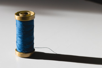 Blue thread with a long shadow and copy space