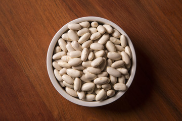 White beans on wood background