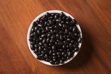 black beans on wood background