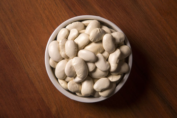 White beans on wood background