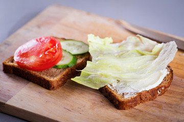 Cooking fresh homemade grilled chicken sandwich on wood