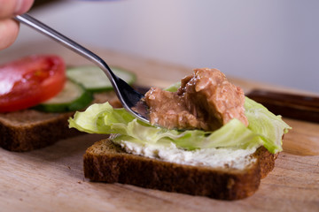 Cooking fresh homemade grilled tuna sandwich on wood