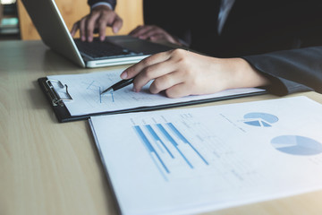 Teamwork of business two colleagues analysis with financial data and marketing report graph, Young co worker discussing and brainstorm new idea for start up project plan, Partner meetings and briefing