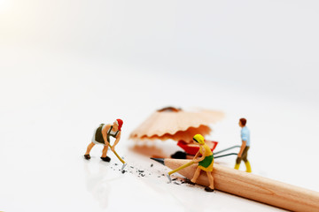 Miniature people cleaning pencil scrap. Concept of cleaning day.