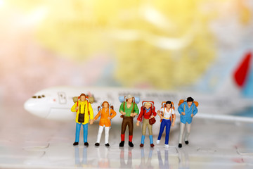 Miniature traveler : backpacker with airplane, travel and business concept.
