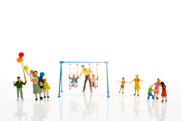 Miniature people, children and family enjoy with swing , happy family day concept.
