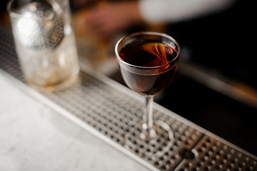 Glass filled with the dark alcoholic drink