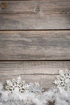 white tinsel and snowflakes on wooden board