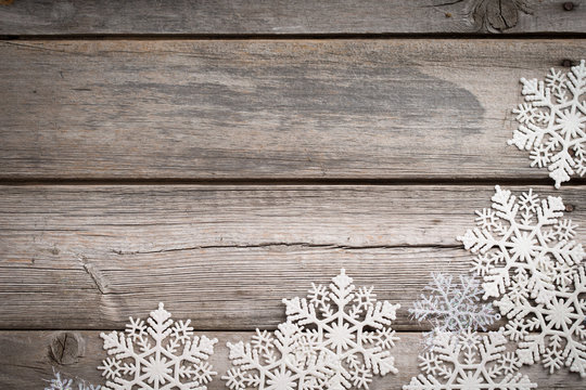 White snowflakes on old wooden