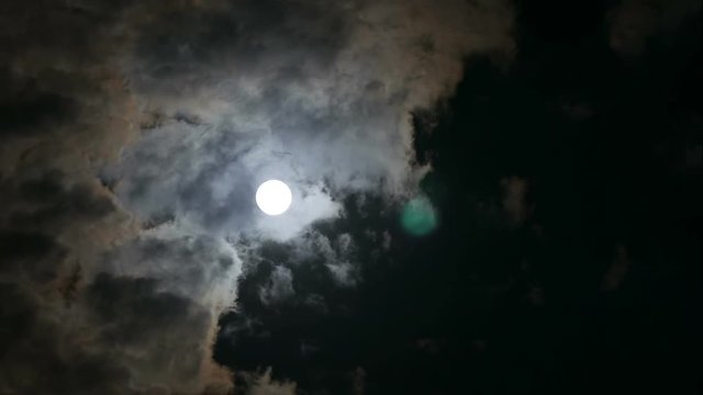 time-lapse of running cloud in the sky with moon
