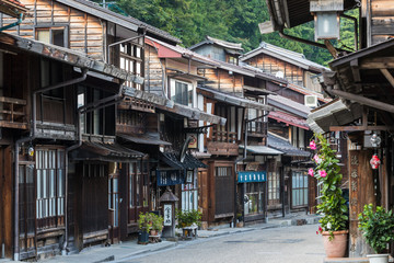Fototapeta premium Narai-juku, Japan - September 4, 2017: Picturesque view of old Japanese town with traditional wooden architecture. Narai-juku post town in Kiso Valley, Japan