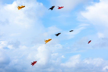Fototapeta na wymiar Colorful kites flying in the sky,kite festival. Background blue sky
