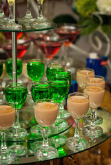 Glass glasses with colored drinks on the table