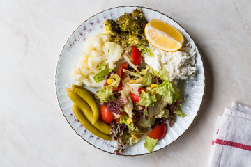 Vegetable Plate with Cauliflower, Celery, Broccoli, Pickle, Tomatoes and lemon.