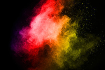 Naklejka na ściany i meble abstract powder splatted background. Colorful powder explosion on black background. Colored cloud. Colorful dust explode. Paint Holi.