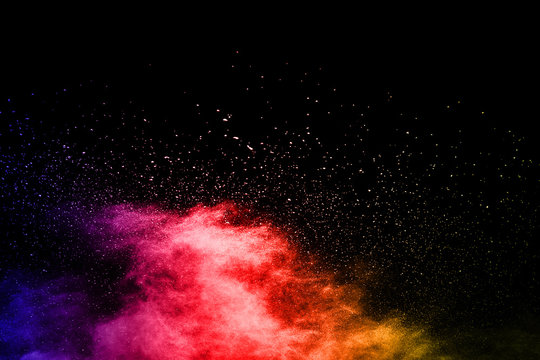 abstract powder splatted background. Colorful powder explosion on black background. Colored cloud. Colorful dust explode. Paint Holi. © kitsana
