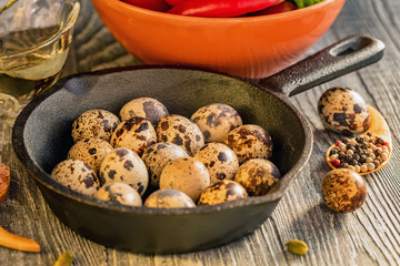 Quail eggs on old brown wooden surface