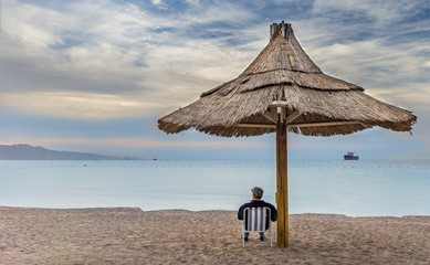 Relaxing atmosphere in the early morning on a public beach of Eilat - famous tourist, resort and recreational city in Israel