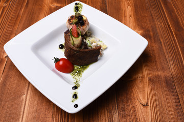 Dish with modern presentation on square plate.