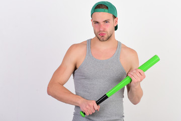 Guy in grey tank top holds bright green bat