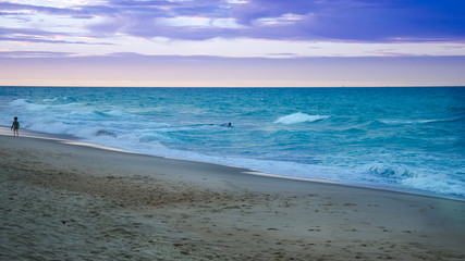 Sunset at the beach with tourists enjoying