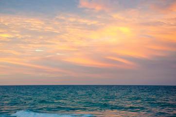 Sunset at the beach with tourists enjoying