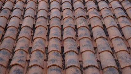 Roof tile with stain in perspective view. Orange color, corrugated surface shape.