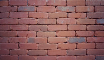 Obraz premium Red brick wall texture in vintage style with corner vignette; narrow block gaps and hidden mortar. Useful for background, backdrop, or interior design. 