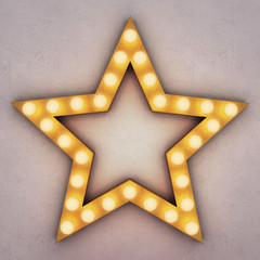 Golden retro star with glowing light bulbs on concrete background. 3D rendering - 185606891