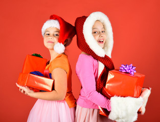 Sisters in Santa Claus hats with gift boxes