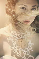 Portrait of young curly blonde girl with broidery. 