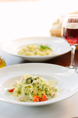 Italian food - fettuccine pasta with pesto sauce.