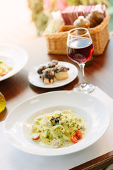 Italian food - fettuccine pasta and pesto sauce with seafood.