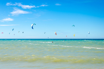 People sailing on their kite board and enjoying